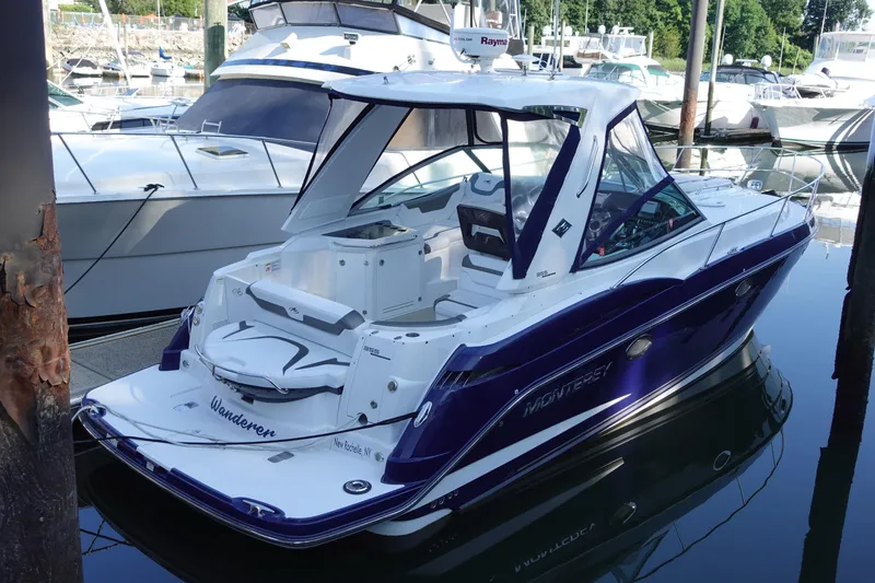 Slide: The Image of 2016 Monterey 355 Sport Yacht docked in a marina, featuring sleek design and modern amenities. - 2