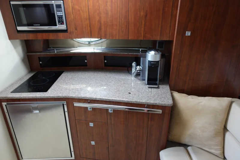 Slide: The Image of Kitchen area of 2016 Monterey 355 Sport Yacht with microwave, stove, and coffee maker. - 25