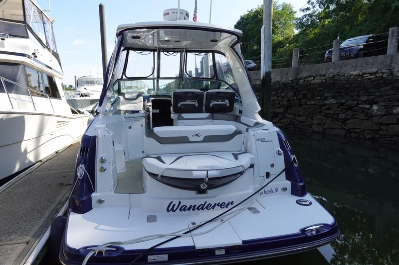 Slide: The Image of 2016 Monterey 355 Sport Yacht docked, rear view with seating and name "Wanderer." - 7