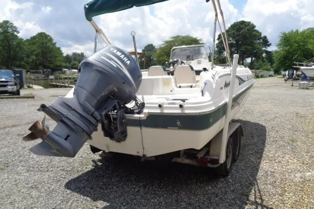 Slide: The Image of 2005 Hurricane GS211 boat with Yamaha outboard motor on a gravel lot. - 12