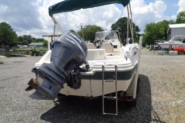 Slide: The Image of 2005 Hurricane GS211 boat with Yamaha outboard motor, parked on gravel lot. - 13