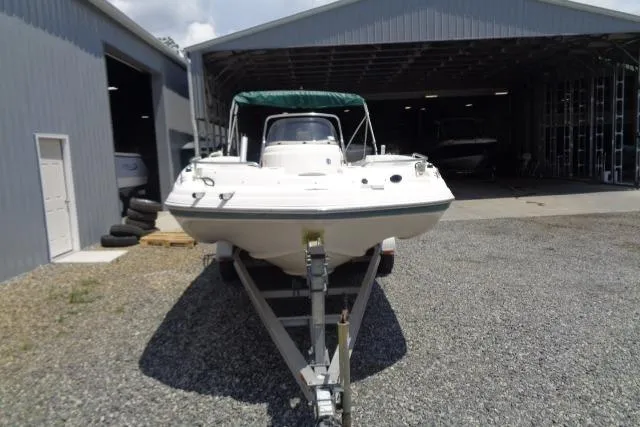 Slide: The Image of 2005 Hurricane GS211 boat on trailer outside storage facility. - 2