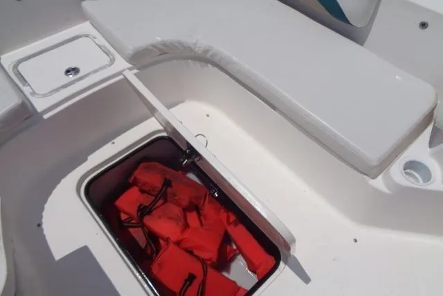 Slide: The Image of Open storage compartment on 2005 Hurricane GS211 boat with red life jackets inside. - 22