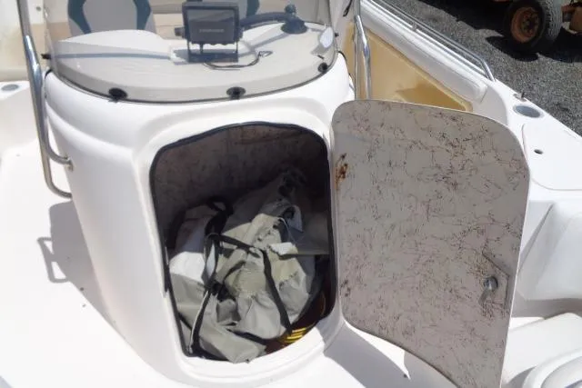 Slide: The Image of Open storage compartment on 2005 Hurricane GS211 boat with gear inside. - 25