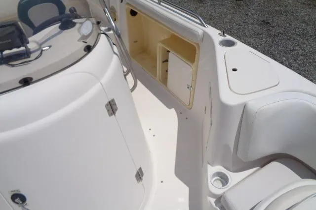Slide: The Image of 2005 Hurricane GS211 boat interior with open storage compartment and seating area. - 26