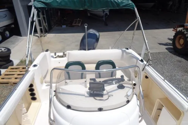 Slide: The Image of 2005 Hurricane GS211 boat interior with green canopy and dual seating. - 28