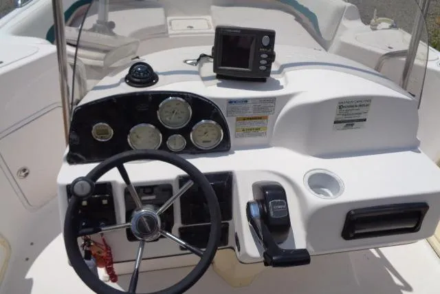 Slide: The Image of Steering console of a 2005 Hurricane GS211 boat with gauges and controls. - 30