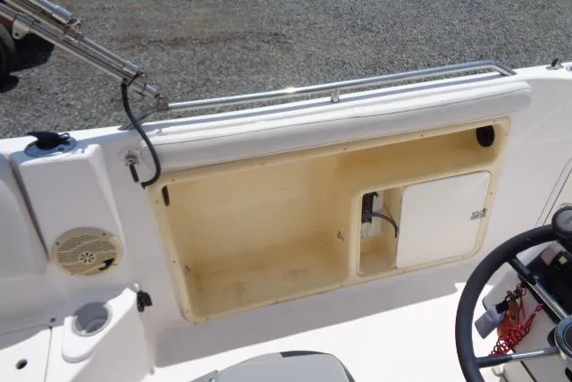 Slide: The Image of 2005 Hurricane GS211 boat interior with storage compartment and steering wheel. - 31