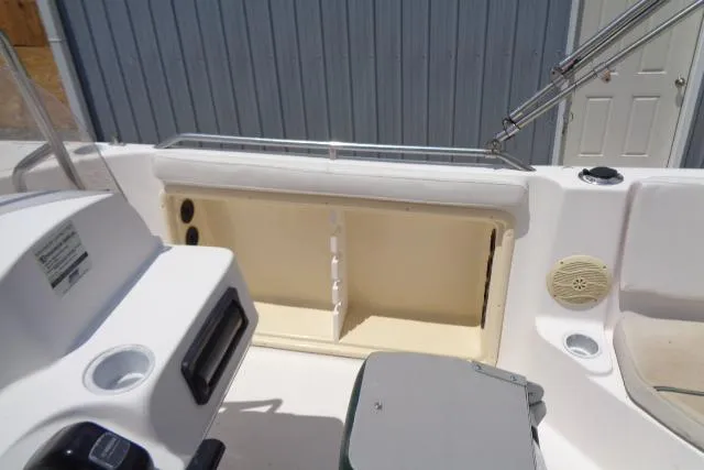 Slide: The Image of 2005 Hurricane GS211 boat interior with storage compartment and seating area. - 32