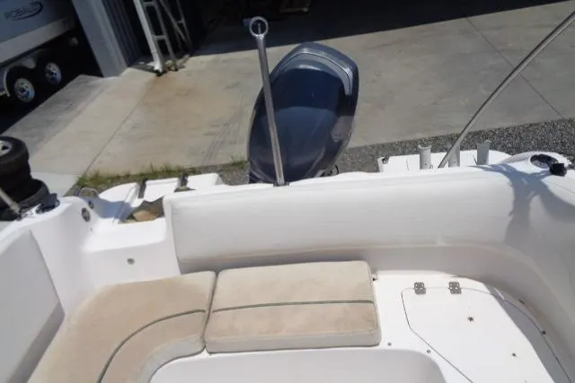 Slide: The Image of 2005 Hurricane GS211 boat interior with cushioned seating and motor view. - 34