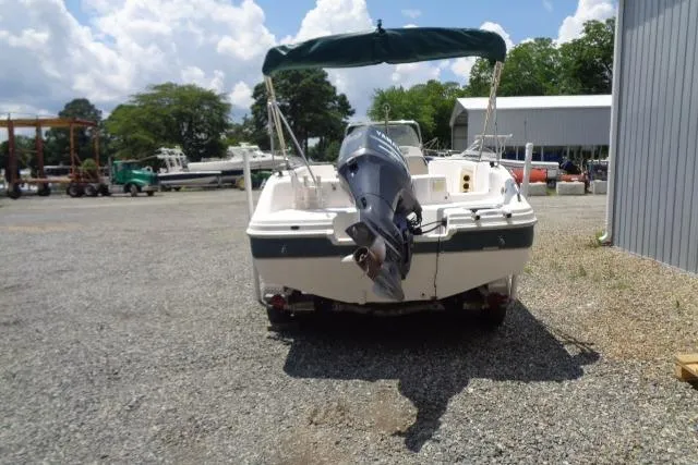 Slide: The Image of 2005 Hurricane GS211 boat with outboard motor in a gravel lot. - 7