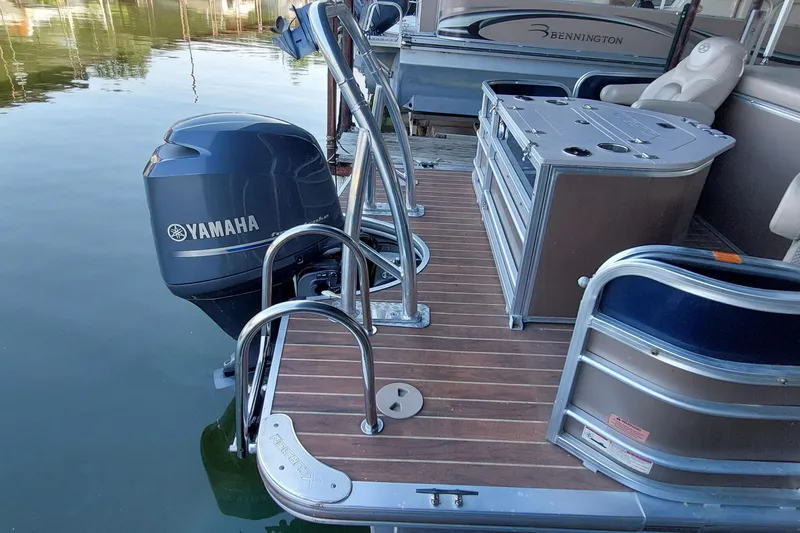 Slide: The Image of 2015 Xcursion 23RFC pontoon boat with Yamaha motor, featuring a sleek deck and seating area. - 2