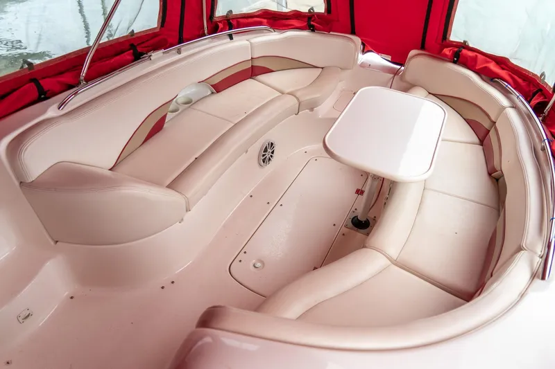 Slide: The Image of 1999 Chaparral 252 Sunesta boat interior with red canopy and white seating. - 11