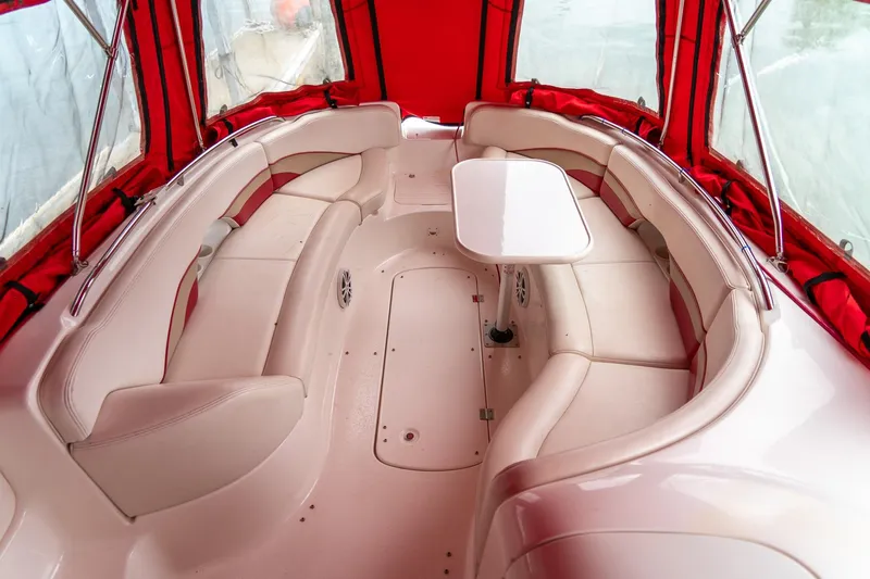 Slide: The Image of 1999 Chaparral 252 Sunesta boat interior with red canopy and white seating. - 12
