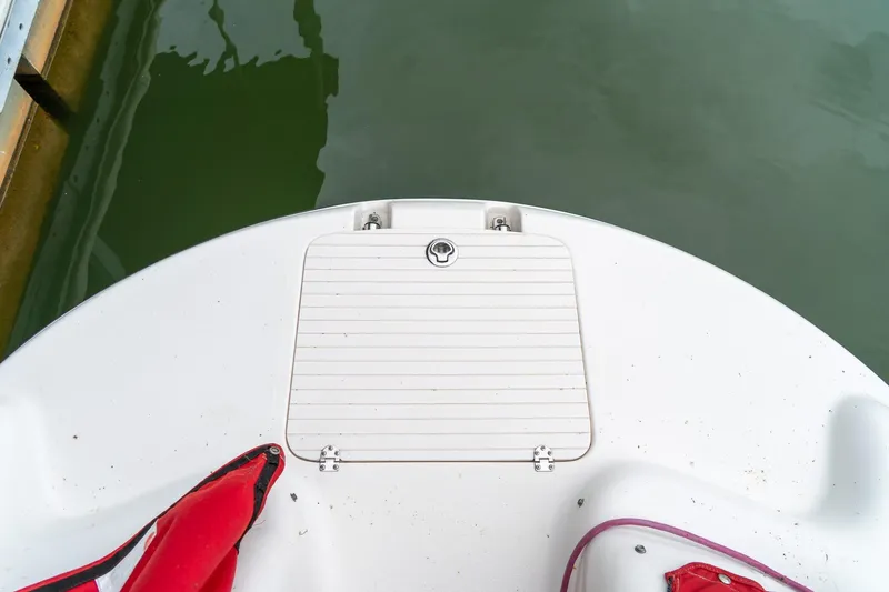 Slide: The Image of 1999 Chaparral 252 Sunesta boat deck with storage hatch and red life jacket. - 13