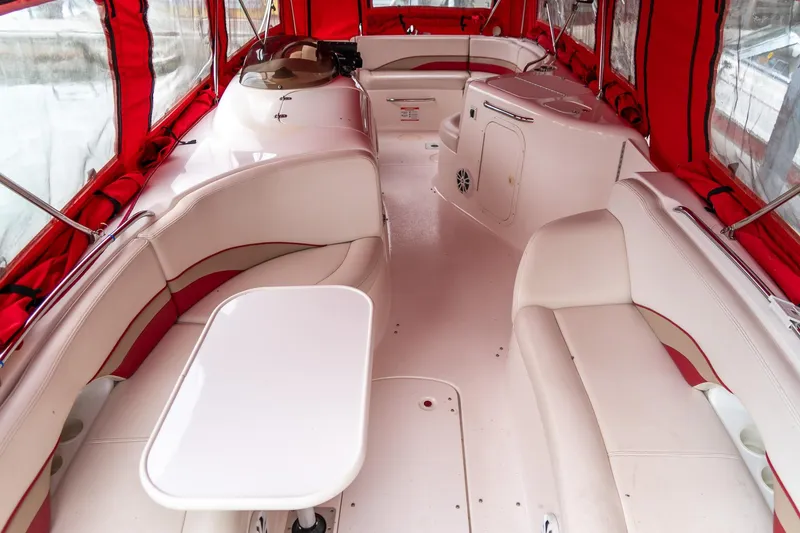 Slide: The Image of 1999 Chaparral 252 Sunesta boat interior with red canopy and white seating. - 14