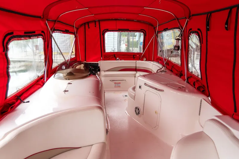 Slide: The Image of 1999 Chaparral 252 Sunesta boat interior with red canopy and white seating. - 15