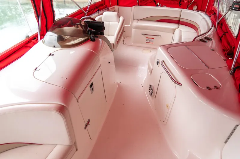 Slide: The Image of 1999 Chaparral 252 Sunesta boat interior with red canopy and white seating. - 16