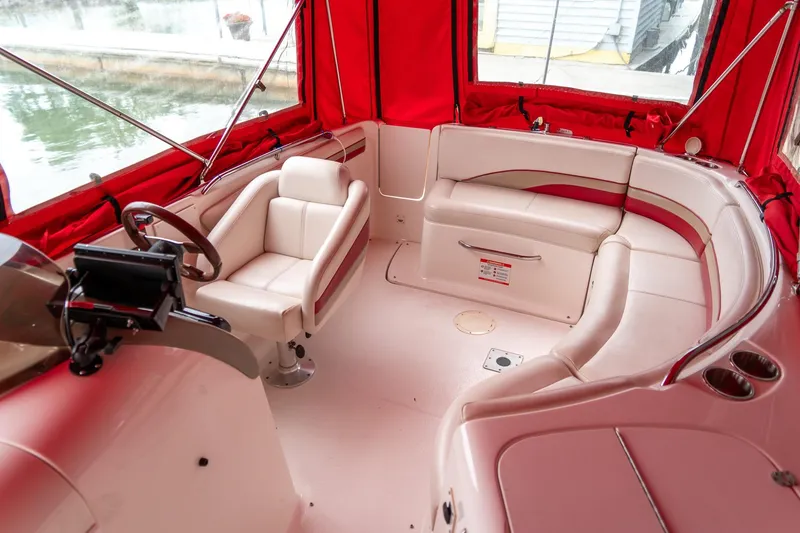Slide: The Image of 1999 Chaparral 252 Sunesta boat interior with red canopy and white seating. - 17