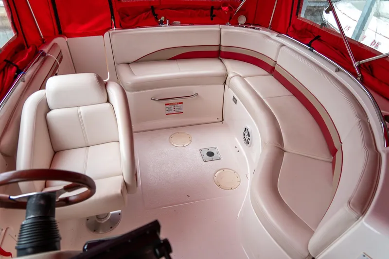 Slide: The Image of 1999 Chaparral 252 Sunesta boat interior with red and white seating and steering wheel. - 20