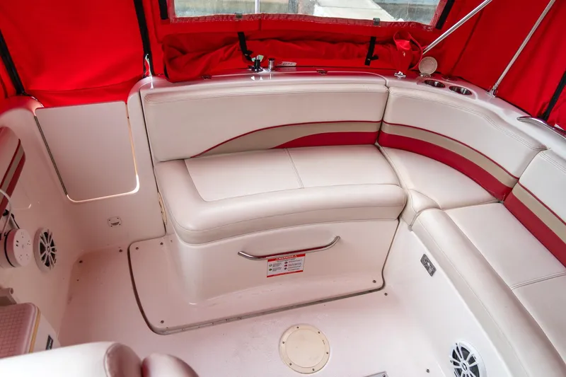 Slide: The Image of 1999 Chaparral 252 Sunesta boat interior with red and white seating and red canopy. - 21