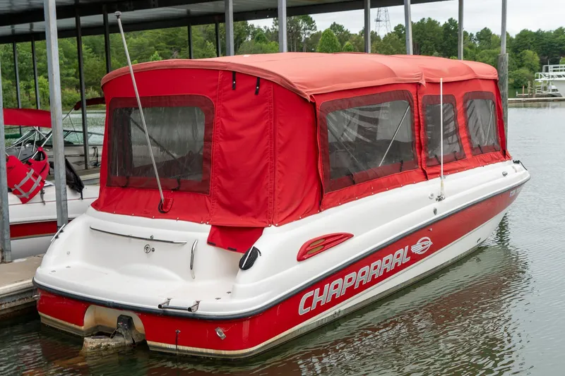 Slide: The Image of 1999 Chaparral 252 Sunesta boat with red canopy docked on a lake. - 3