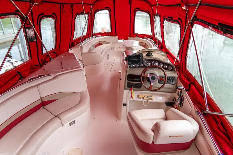 Slide: The Image of 1999 Chaparral 252 Sunesta boat interior with red canopy and beige seating. - 6