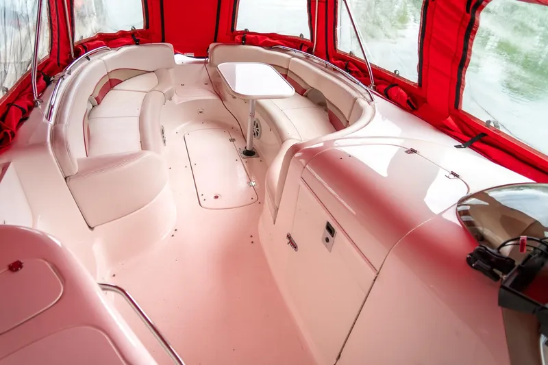 Slide: The Image of 1999 Chaparral 252 Sunesta boat interior with red canopy and white seating. - 9