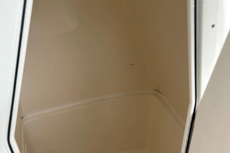 Slide: The Image of 2020 Cobia 201 Center Console storage compartment interior view. - 11