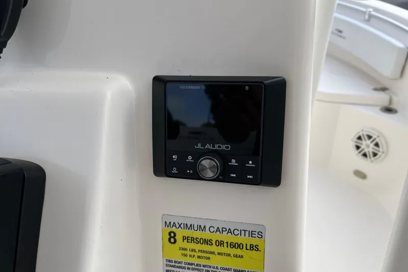 Slide: The Image of 2020 Cobia 201 Center Console with JL Audio system and capacity label. - 15