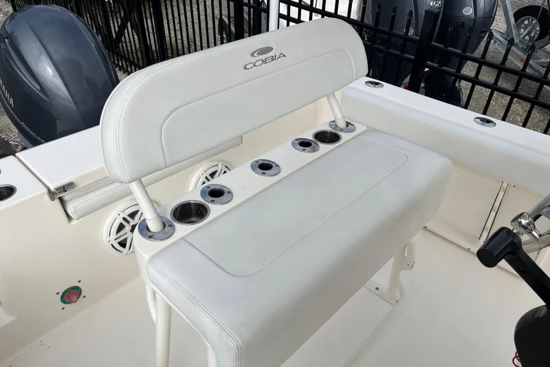Slide: The Image of 2020 Cobia 201 Center Console boat interior with white seating and cup holders. - 16