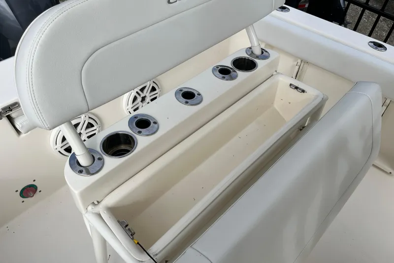 Slide: The Image of 2020 Cobia 201 Center Console boat seating with cup holders and storage compartment. - 17