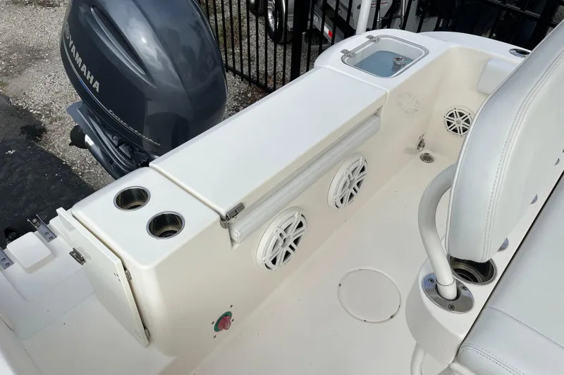 Slide: The Image of 2020 Cobia 201 Center Console boat interior with Yamaha engine, featuring cup holders and speakers. - 18