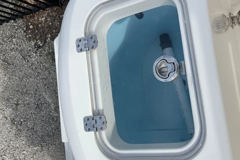 Slide: The Image of Livewell on a 2020 Cobia 201 Center Console boat, featuring a secure latch. - 22