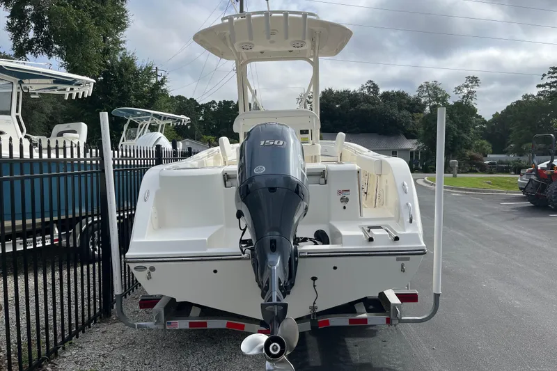 Slide: The Image of 2020 Cobia 201 Center Console boat with outboard motor, parked on a trailer. - 3