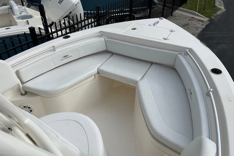Slide: The Image of 2020 Cobia 201 Center Console boat with white cushioned seating and sleek design. - 4
