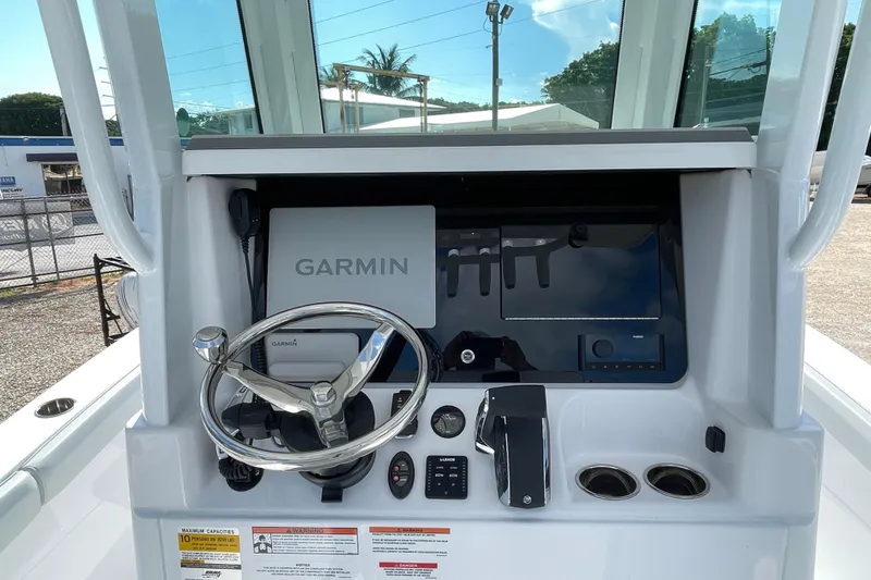 Slide: The Image of Helm of 2026 Blackfin 242HB boat with Garmin navigation system and steering wheel. - 13