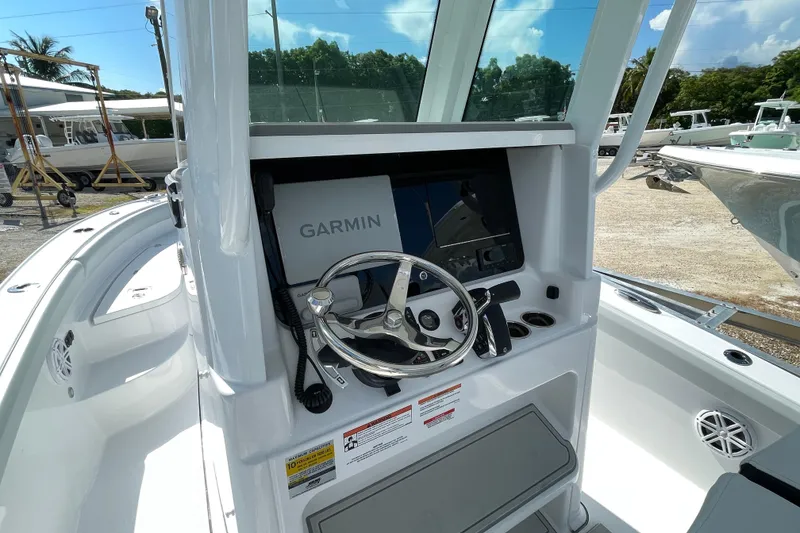 Slide: The Image of 2026 Blackfin 242HB boat dashboard with Garmin navigation system and steering wheel. - 17