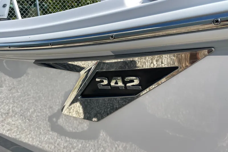 Slide: The Image of 2026 Blackfin 242HB boat emblem with sleek metallic design. - 22