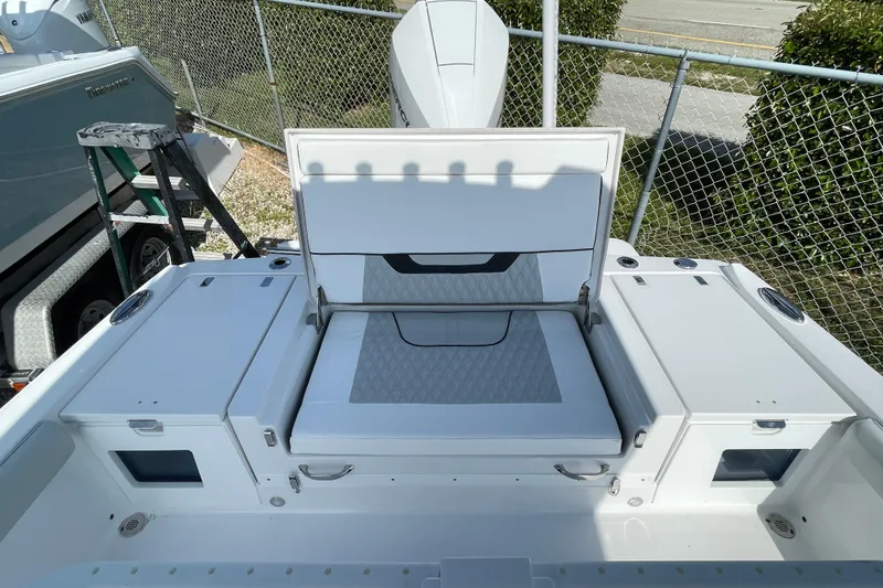 Slide: The Image of 2026 Blackfin 242HB boat interior with open storage compartments and seating. - 24