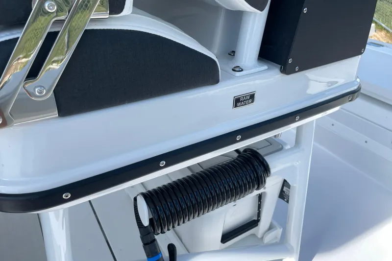 Slide: The Image of 2026 Blackfin 242HB boat detail with raw water access and coiled hose. - 29