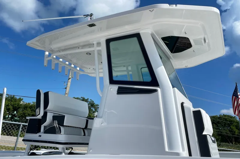 Slide: The Image of 2026 Blackfin 242HB boat with sleek design, modern seating, and T-top under a clear blue sky. - 3