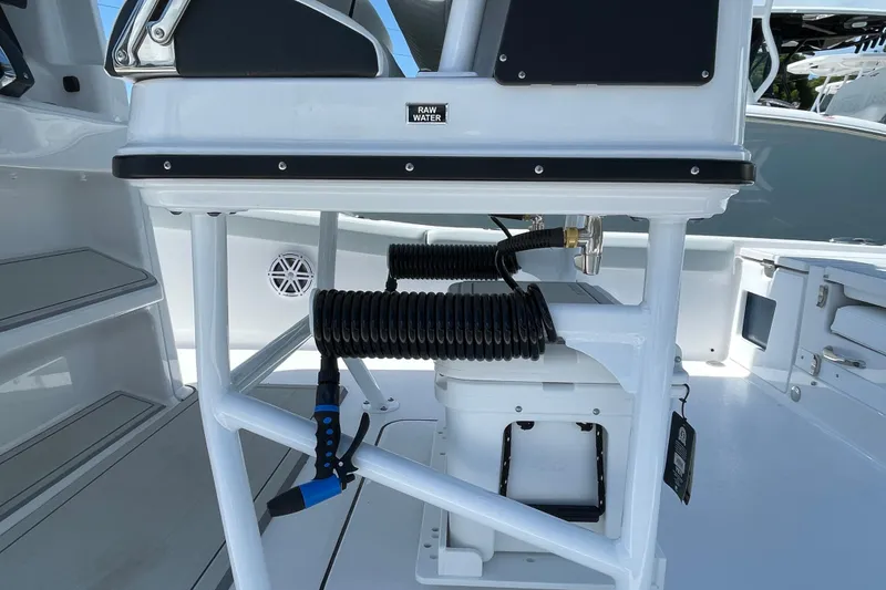 Slide: The Image of 2026 Blackfin 242HB boat interior with raw water system and coiled hose. - 30