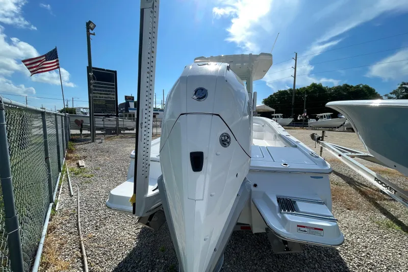 Slide: The Image of 2026 Blackfin 242HB boat displayed outdoors with American flag in background. - 35