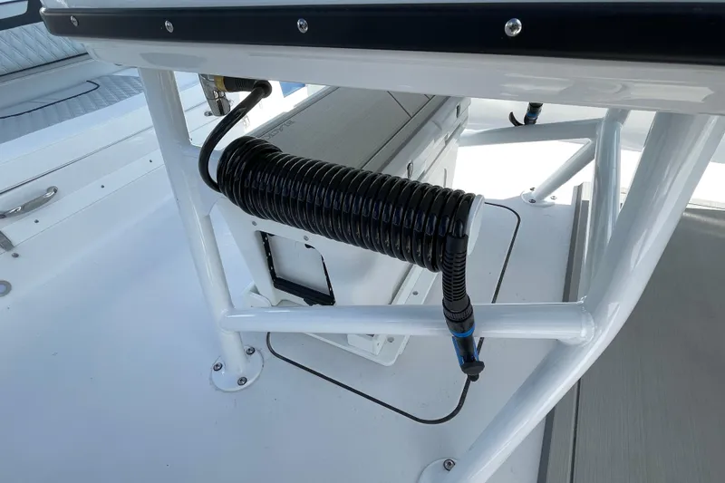 Slide: The Image of 2026 Blackfin 242HB boat interior with coiled hose and storage compartment. - 37