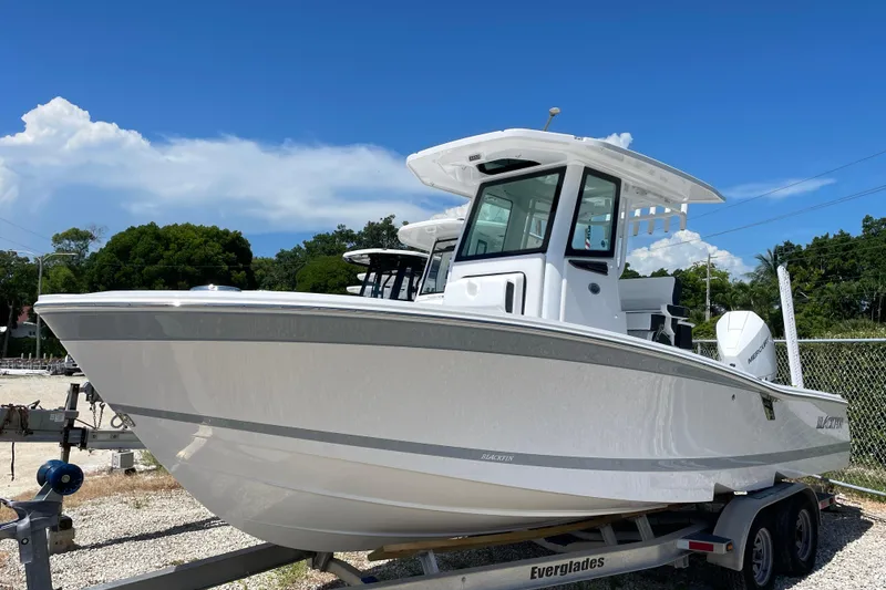 Slide: The Image of 2026 Blackfin 242HB boat on trailer under clear blue sky. - 38
