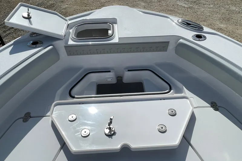 Slide: The Image of Bow area of 2026 Blackfin 242HB boat with storage compartments and measuring ruler. - 5