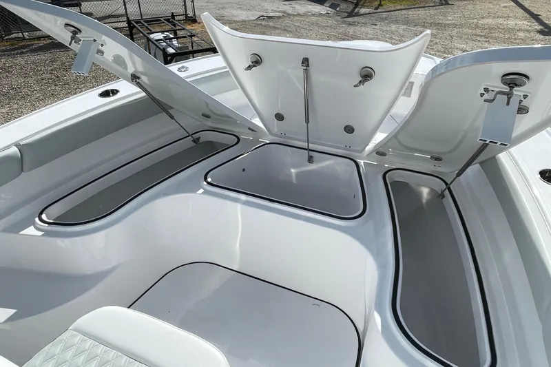 Slide: The Image of 2026 Blackfin 242HB boat with open storage compartments, showcasing sleek design and functionality. - 8