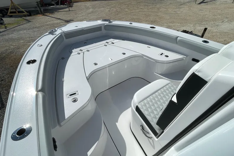 Slide: The Image of 2026 Blackfin 242HB boat interior with white seating and storage compartments. - 9