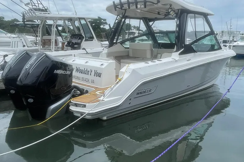 The Image of 2023 Boston Whaler 280 Vantage boat docked, featuring dual Mercury engines. - 0